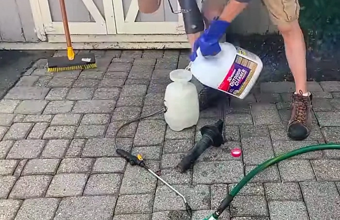 mixing bleach with water to apply on moss