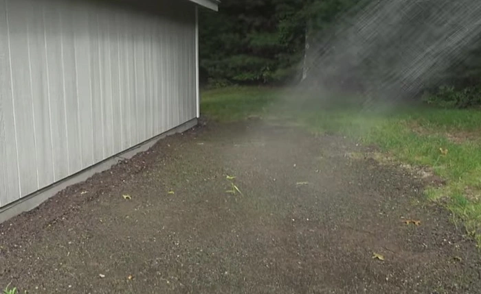 image of watering hydro seeded lawn area