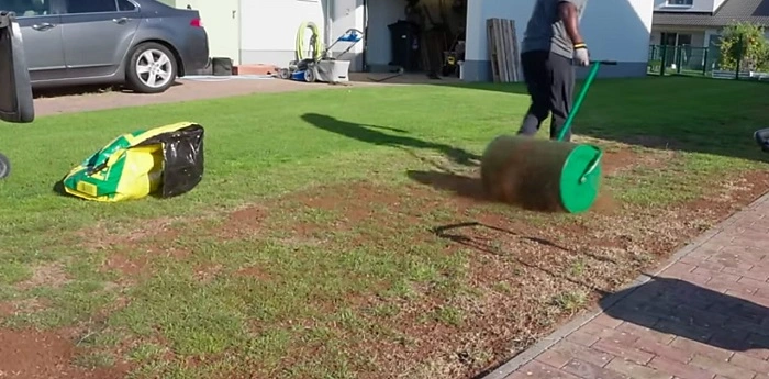 image of applying mulch on the newly grown grass