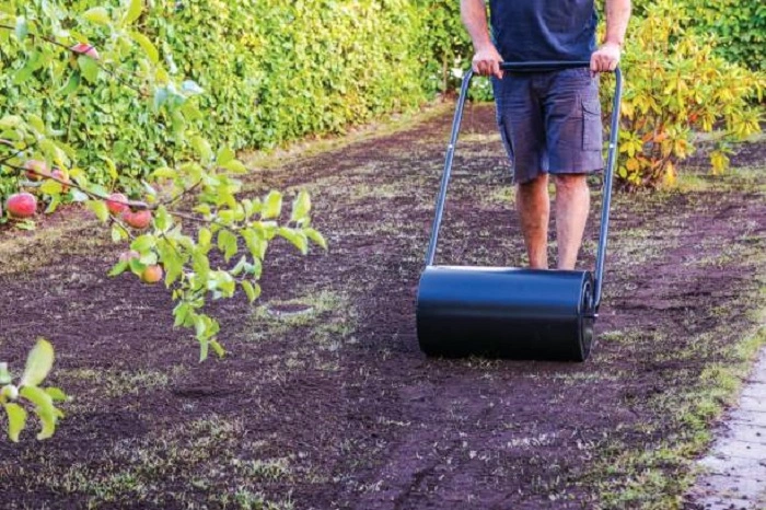 image of compacting lawn soil