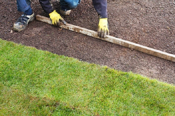 image of leveling hard dirt for planting grass seeds