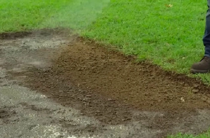 image of watering soil before sod installation