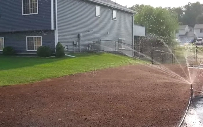 image of watering newly seeded lawn